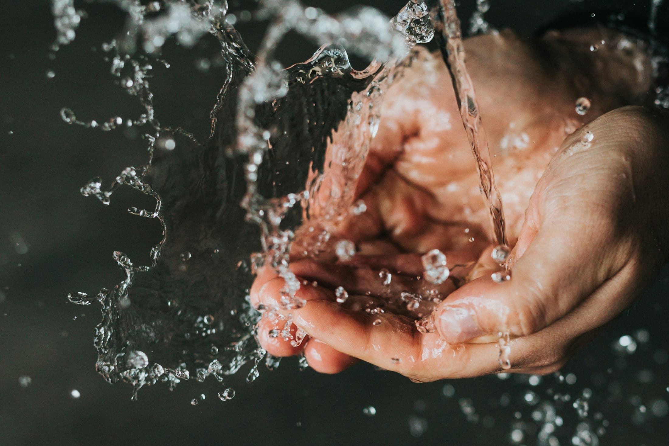 Water splashing over cupped hands